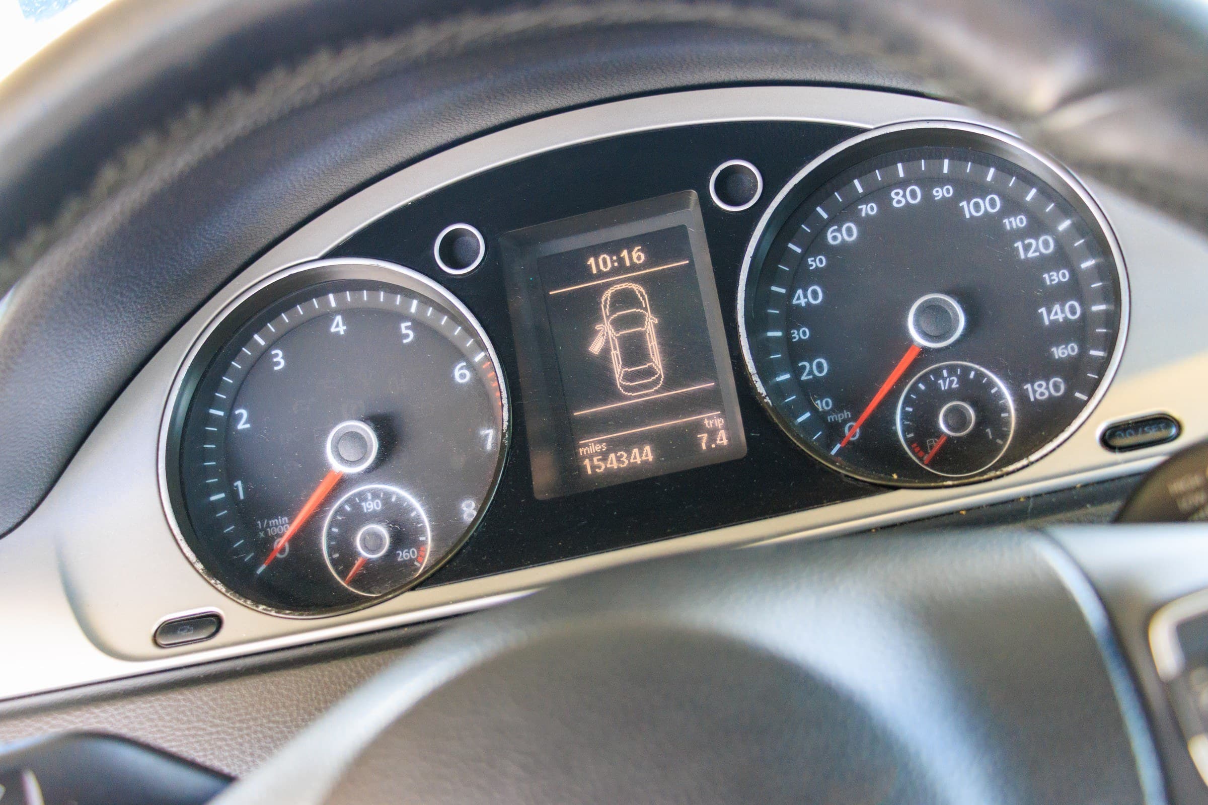 Close-up of the Volkswagen CC's instrument cluster; the odometer reads 154,344 miles.