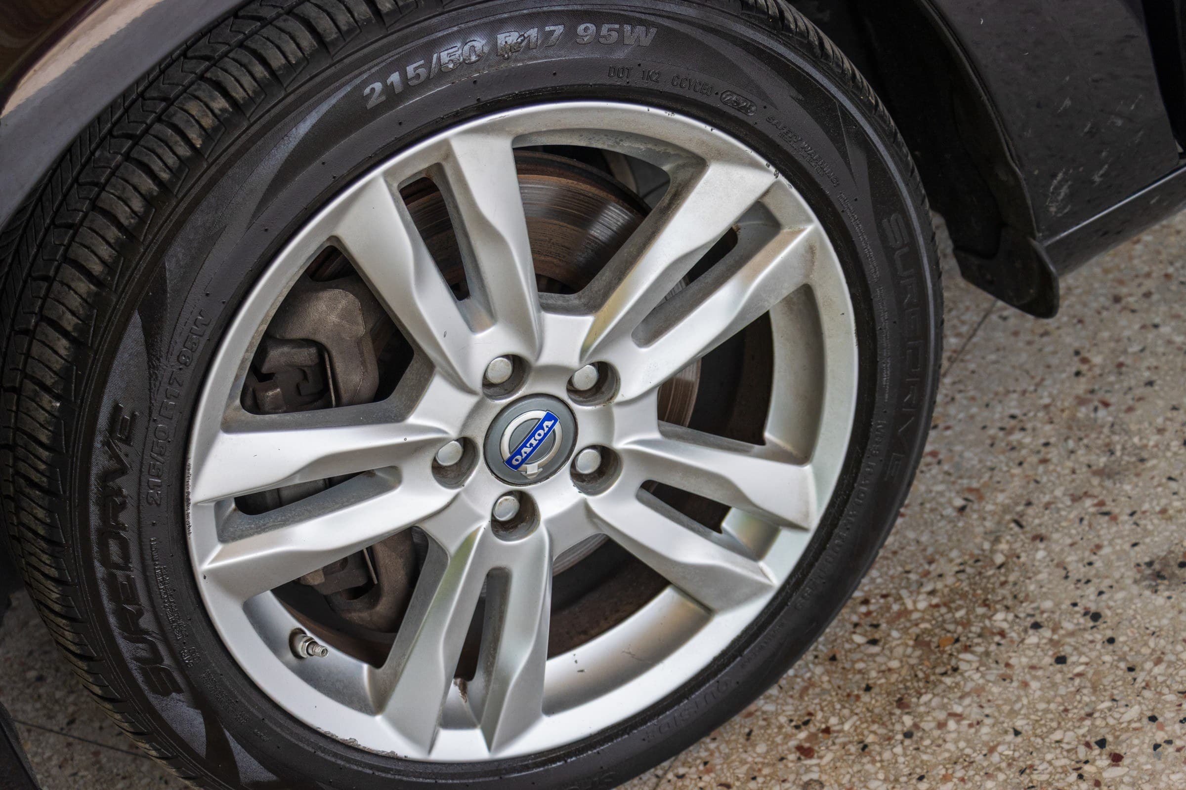 Close-up of a silver Volvo alloy wheel with a 215/50 R17 tire.