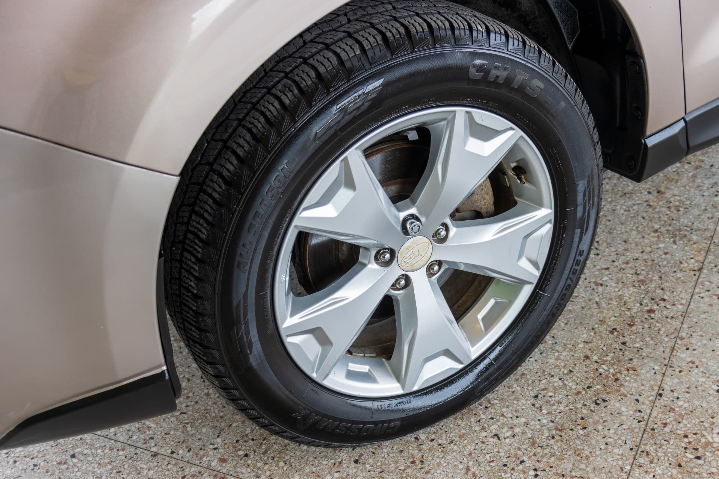Close-up of a silver Subaru alloy wheel with a 225/60 R17 all-season tire.