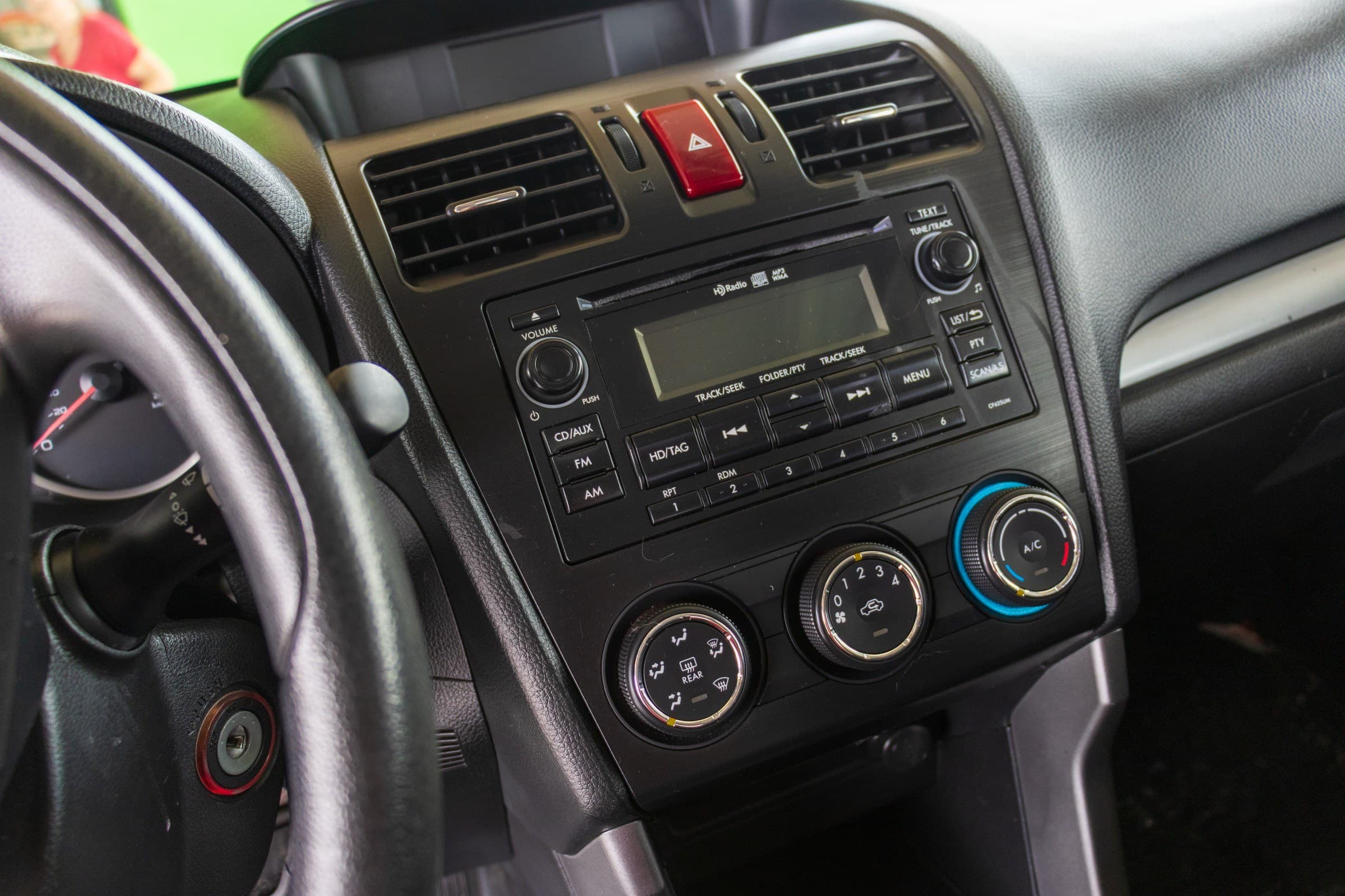 The Forester's centre stack, with a CD and HD Radio head unit above three rotary heating and air-conditioning dials.